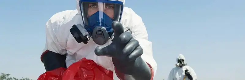 sewage clean up technician wearing protective gear handling biohazard materials in Jacksonville, FL