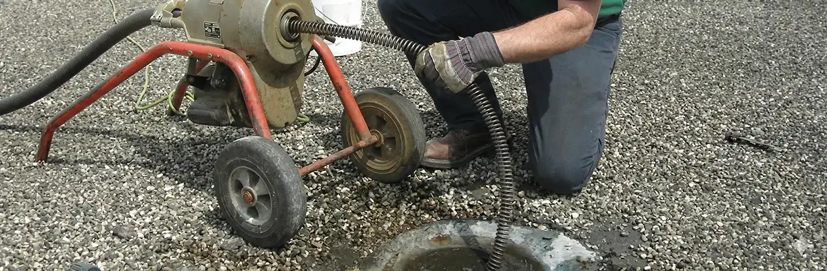 sewer rodding technician actively removing blockages from a sewer line in Jacksonville, FL